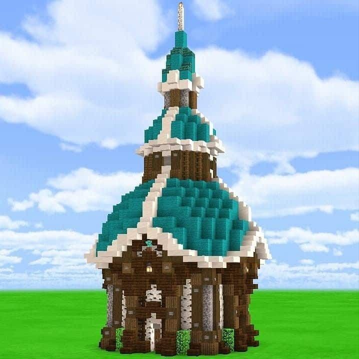 a small building made out of legos in the middle of a field with blue sky and clouds