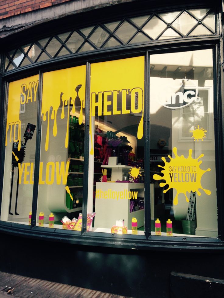 a store front window with yellow and black paint