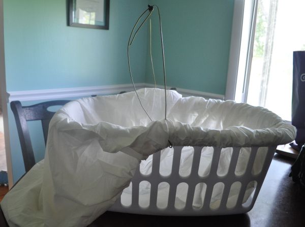 a white laundry basket sitting on top of a wooden table