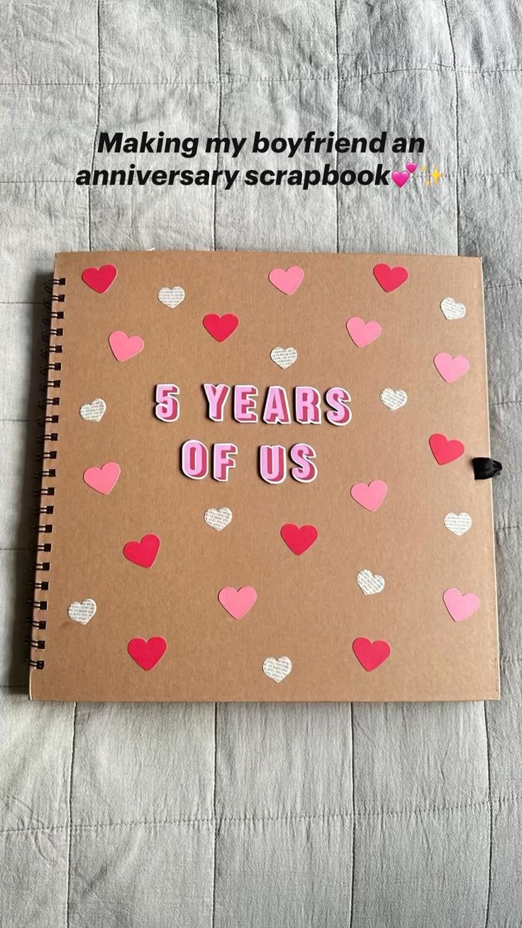 a brown notebook with pink and white hearts on it