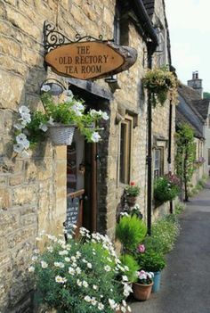 the old factory tea room is located in an old stone building with potted plants outside