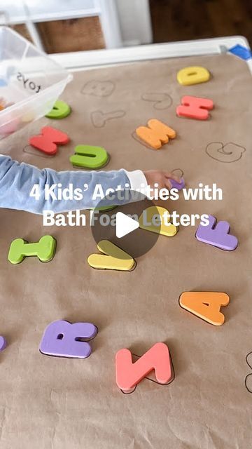 a little boy that is standing in front of some letters on a sheet of paper