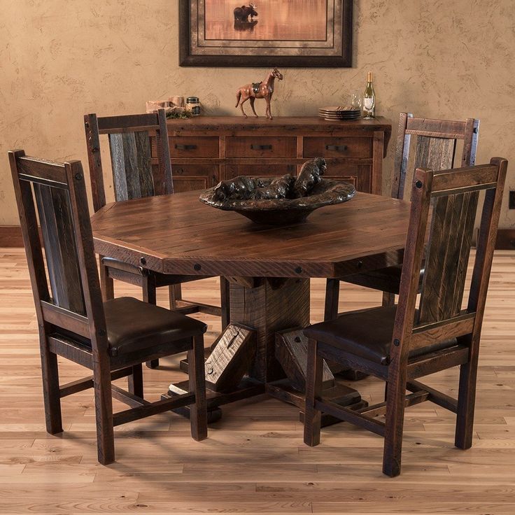 a wooden table with chairs around it and a bowl on top of the dining room table