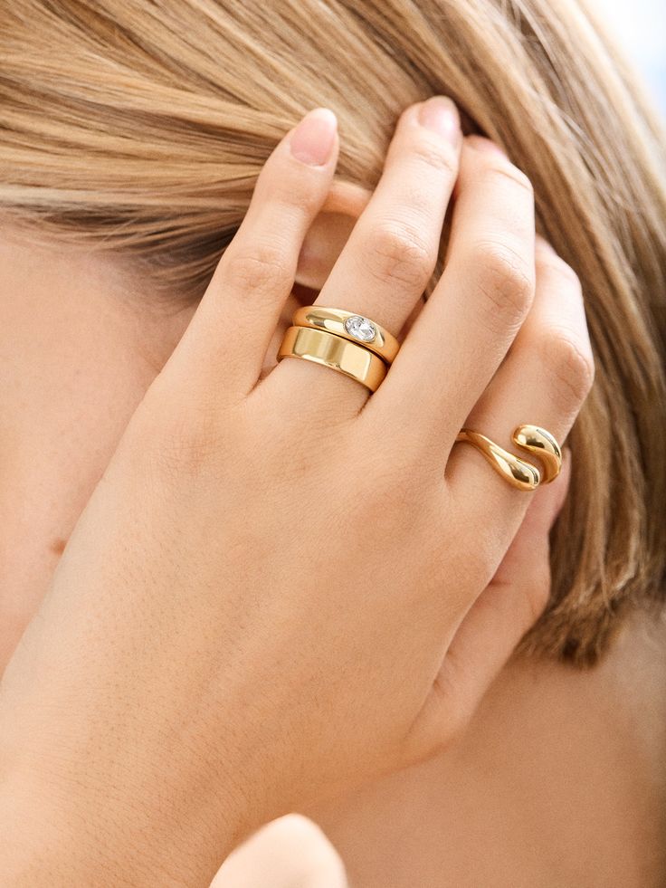 Elevate your everyday jewelry looks with the Stevie Ring, It's classic gold and in a thick, chic band, making it perfect for a bold solo statement or for effortless stacking when your fingers feel a little naked. Always timeless, slip it on and let the compliments roll in. Adjustable Solitaire Rings For Everyday, Adjustable Everyday Rings With Round Band, Everyday Adjustable Round Band Rings, Timeless Thick Band Adjustable Ring, Timeless Adjustable Ring With Thick Band, Adjustable Round Band Rings For Everyday Wear, Timeless Adjustable Thick Band Ring, Adjustable Stackable Wide Band Ring For Everyday, Classic Adjustable Diamond Ring For Everyday