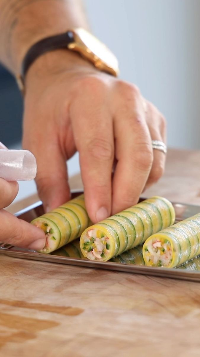 a person cutting up some food on top of a wooden table