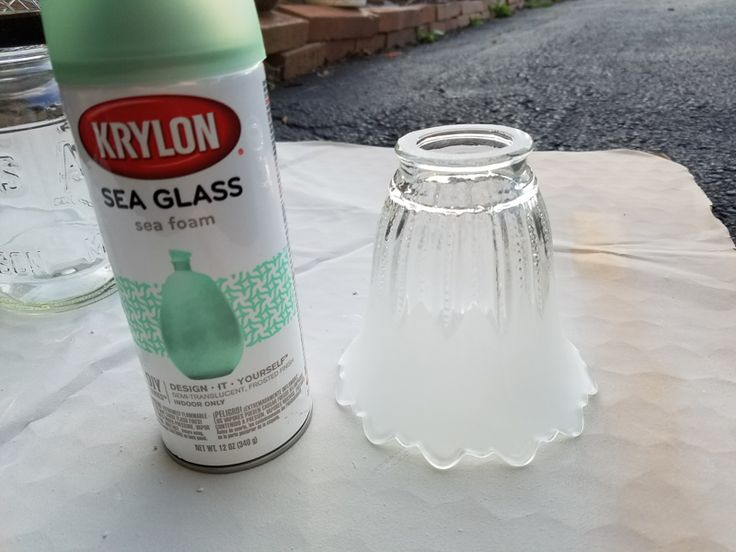 a can of krylon sea glass next to an empty vase on a table