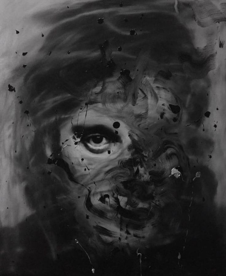 a black and white photo of a man's face with paint splatters all over it