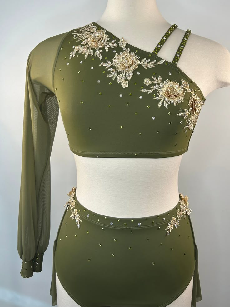 a woman's green and white top with flowers on the chest, in front of a mannequin