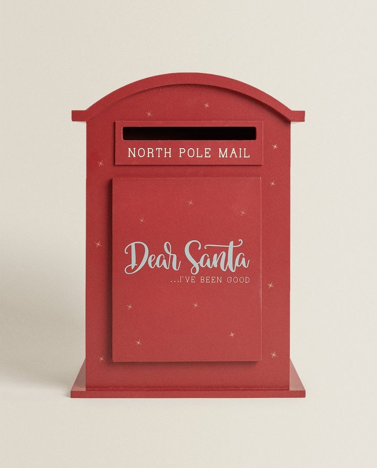 a red mailbox with the words dear santa written on it and an envelope in front