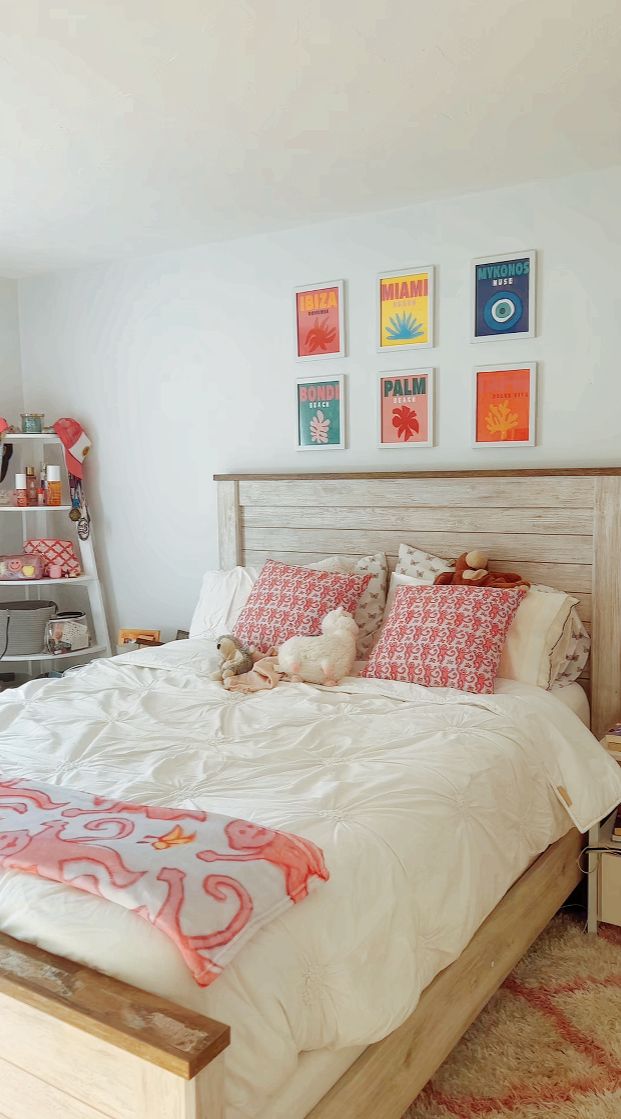 a bedroom with a large bed and pictures on the wall