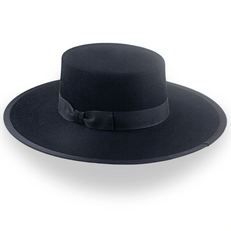 Description Materials Craftsmanship Hat Care Shipping Returns Product Description Bold Black Spanish Flat Cowboy Hat: A Timeless Statement Piece Introducing the Gaucho, a striking black Spanish flat cowboy hat that embodies the spirit of southwestern style with a modern twist. Masterfully handcrafted from premium black fur felt, this bolero-style hat features a distinctive flat crown and wide brim, creating a silhouette that commands attention. The Gaucho is custom-tailored to your measurements, Mens Felt Hats, Best Cowboy Hats, Spanish Hat, Homburg Hat, Bolero Hat, Gambler Hat, Mens Hats Fashion, Fedora Hat Men, Homburg