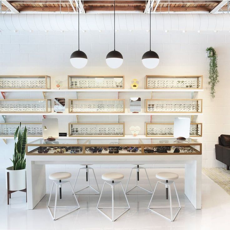 a room filled with lots of counter top space and lights hanging from the ceiling above it