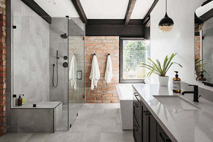 a bathroom with two sinks and brick walls