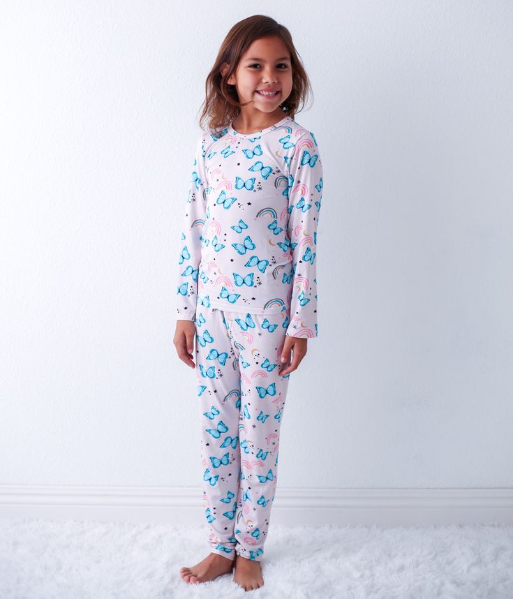 "Get ready for some magical dreams with our Retro Rainbows Pajama. Made from soft bamboo, this playful pajama features a print of rainbows and butterflies, aptly named 'Retro Rainbows'. Say goodbye to scratchy, uncomfortable pajamas and hello to cozy, whimsical nights!" 93% Bamboo; 7% Spandex Wash cold with like colors; stays soft wash after wash Fits snug; not treated with flame retardants Unicorn Print Cotton Sleepwear For Loungewear, Cute Unicorn Print Sleepwear For Loungewear, Playful Unicorn Print Sleepwear For Sleepover, Playful Unicorn Print Sleepwear, Pink Unicorn Print Sleepwear For Bedtime, Pink Unicorn Print Sleepwear, Rainbows And Butterflies, Toddler Pajamas, Blue Butterflies