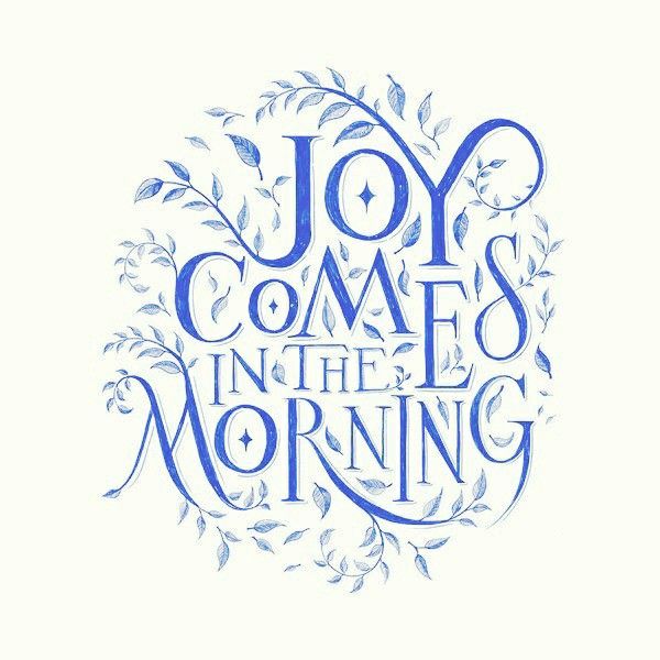 the words joy comes in the morning are drawn with blue ink