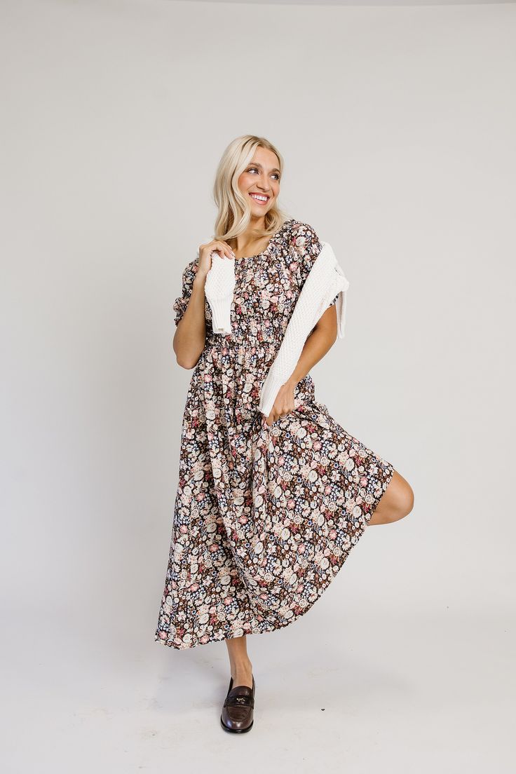 Meet your new dream dress! You’ll be sure to feel like a woodland princess in this deep, moody floral maxi dress! She’s stunning and bold with all of the best details. The deep brown backdrop of ethereal florals is truly the showstopper. The mini ruffled elastic scoop neck carries through to the back of the dress, allowing the dress to be nursing friendly. The bust is pleated with a three tiered elastic, smocked waistband which makes this dress forgiving, flattering and extremely comfortable. We Fall Flowy Maxi Dress With Ditsy Floral Print, Fall Ditsy Floral Print Maxi Dress, Modest Floral Print Maxi Dress For Fall, Fall Garden Party Floral Maxi Dress, Brown Floral Print Maxi Dress For Garden Party, Brown Floral Print Midi Dress For Fall, Brown Floral Print Midi Dress, Casual Brown Midi Dress With Floral Print, Brown Floral Print Dress For Dress Down Occasions