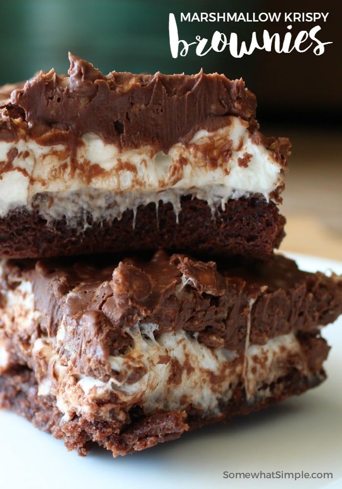 marshmallow krispy brownies stacked on top of each other with chocolate and white frosting