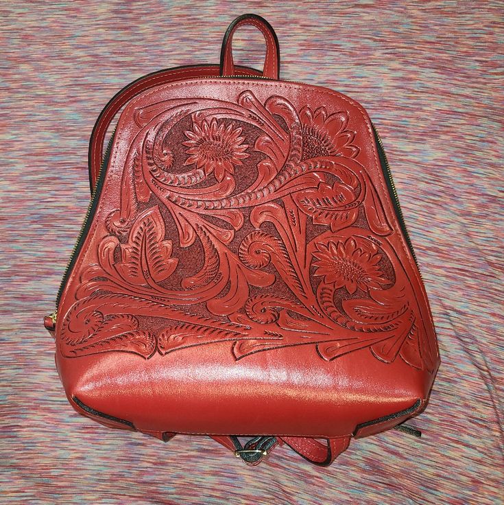 Hand Tooled Leather Bag All Our Products Are Handcrafted With Great Attention To Detail. 100% Genuine Leather Exterior And Leather Interior. Bag Inside: Luxurious Suede, Zipper Pocket, A Divider Compartment Never Used Msrp: $250 + Ship + Tax Luxury Red Backpack Bags, Classic Red Backpack For Daily Use, Classic Red Leather Backpack, Red Leather Standard Backpack, Classic Red Backpack, Red Leather Backpack Bag, Red Backpack With Removable Pouch, Classic Red Leather Everyday Backpack, Classic Red Leather Backpack For Everyday