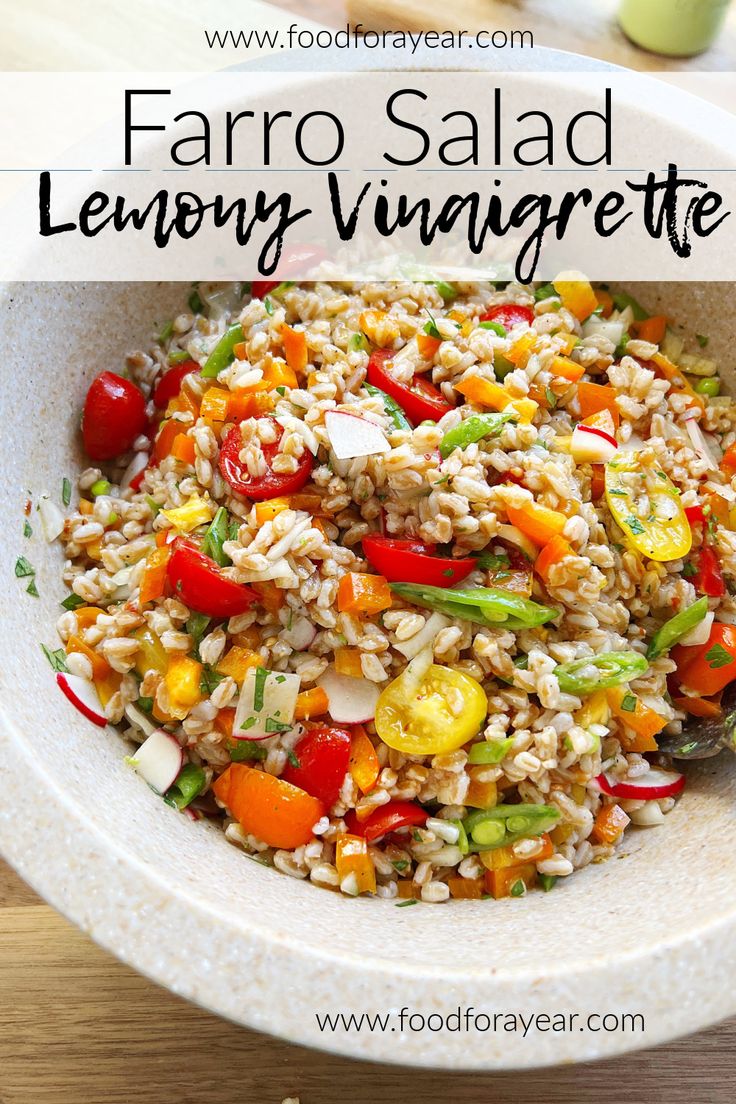 a bowl full of farro salad with lemony vinaigrete and tomatoes