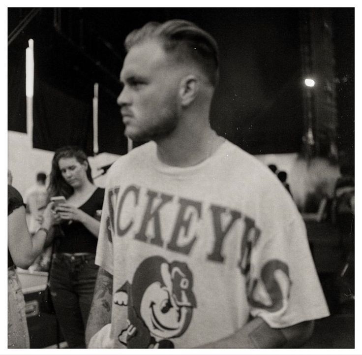 a black and white photo of a man in a t - shirt