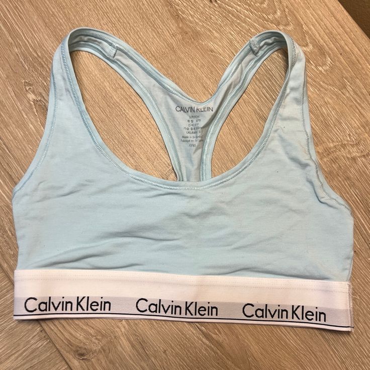 Size Small But Fits More Like An Xs. Never Worn. Unlined Cotton Bralette/ Sports Bra With Signature Calvin Klein Band. Blue Racerback Sports Bra With Adjustable Straps, Spring Stretch Calvin Klein Bra, Fitted Calvin Klein Bra For Summer, Calvin Klein Fitted Bra For Summer, Calvin Klein Seamless Spring Bra, Fitted Calvin Klein Summer Bra, Casual Blue Fitted Bra, Blue Sports Bra, Calvin Klein Bra