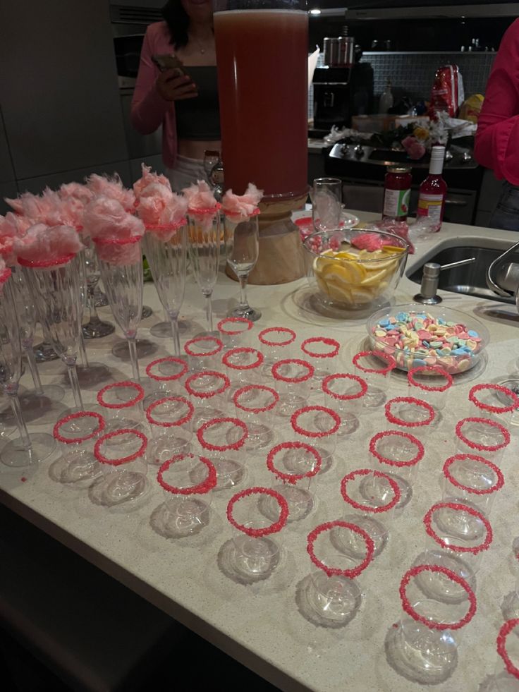 the table is set up with desserts and wine glasses