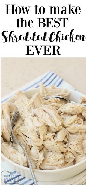 a white bowl filled with shredded chicken on top of a table