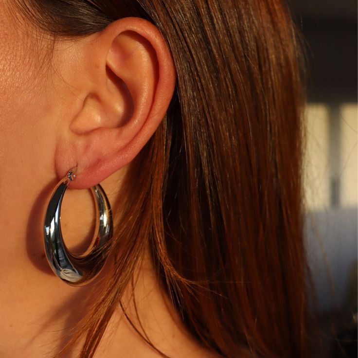 For a simple pair of earrings that always look fabulous, choose these light weight hoop earrings. With a hollow middle, made from stainless steel and finished with sterling silver plating, these earrings are incredibly versatile. We love the shiny silver and the lightweight feel for all day comfort. The bigger style hoop is great for making a statement, while being comfortable and easy to wear. Choose this pair for your jewellery box today. Clean with a jewellery polishing cloth. Store in a safe place separately to avoid scratching. Modern Metal Hoop Earrings For Everyday Wear, Modern Metal Hoop Earrings For Everyday, Minimalist Metal Earrings With Shiny Finish, Modern Nickel-free Hoop Earrings For Everyday, Silver Stainless Steel Earrings With Polished Finish, Everyday Modern Nickel-free Hoop Earrings, Sleek Silver Jewelry With Shiny Finish, Polished Silver Stainless Steel Earrings, Polished Stainless Steel Silver Earrings