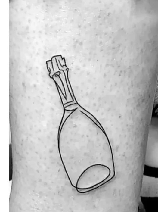 a black and white photo of a bottle tattoo