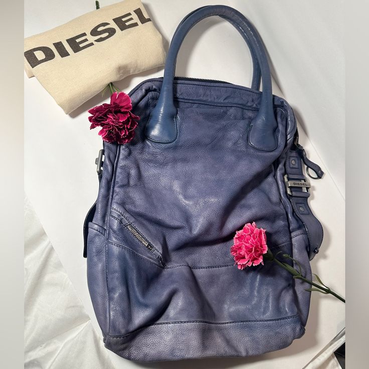 Diesel Tote Bag Purple/Blue With Metal Accents Purse Is A Longer Version Of A Tote Bag 100% Leather Never Worn Pet Free Smoke-Free Home Duster Bag Included Designer Blue Bags For Everyday Use, Modern Purple Shoulder Bag, Designer Purple Travel Bag, Modern Purple Bag For Everyday Use, Modern Purple Bags For Everyday Use, Designer Purple Bags With Handles, Modern Purple Satchel For Daily Use, Designer Purple Shoulder Bag With Handles, Purple Designer Shoulder Bag