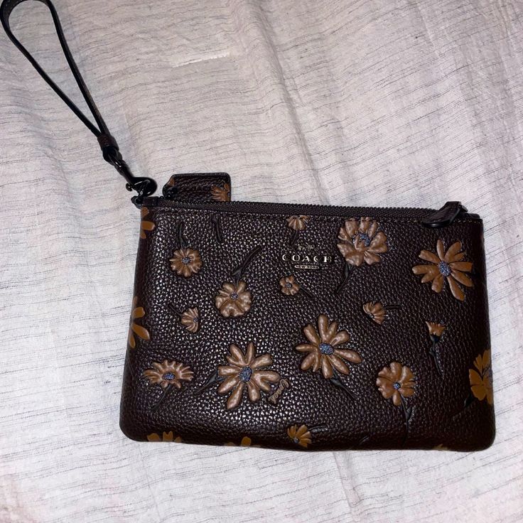 Coach Floral Wristlet, Never Used Brown Clutch With Removable Pouch, Coach Brown Bag As Gift, Coach Brown Bag As A Gift, Coach Brown Bag For Gift, Brown Clutch Pouch With Wrist Strap, Brown Textured Leather Clutch For Daily Use, Brown Clutch Wristlet For Everyday Use, Brown Wristlet With Removable Pouch As Gift, Brown Clutch Wristlet