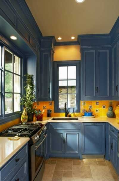 the kitchen is painted blue and has yellow counter tops on both sides of the sink