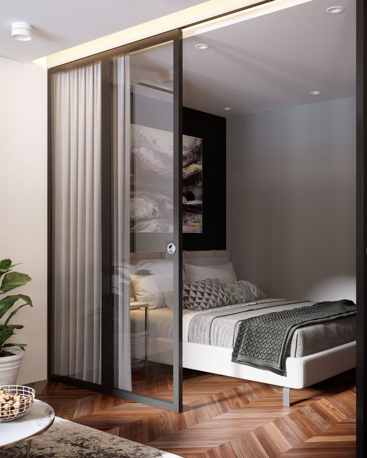 a bedroom with sliding glass doors leading to the bed