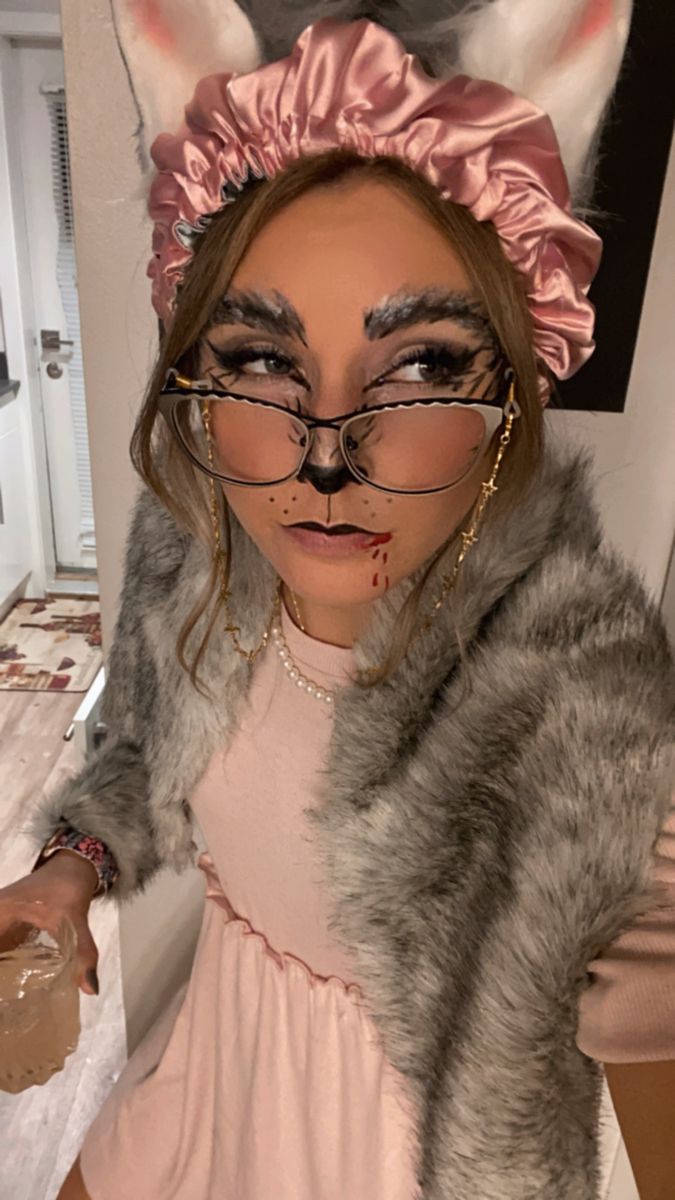 a woman wearing glasses and a cat costume