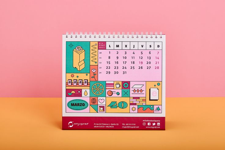 a calendar on a table with a pink background