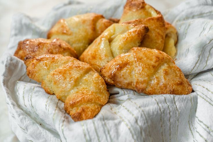 small pastries are sitting on a white cloth