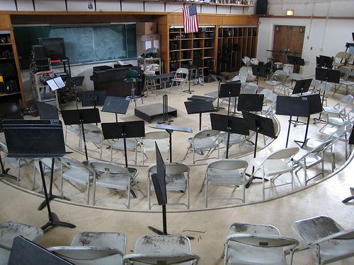 an empty classroom with chairs and desks in the middle is seen from above,