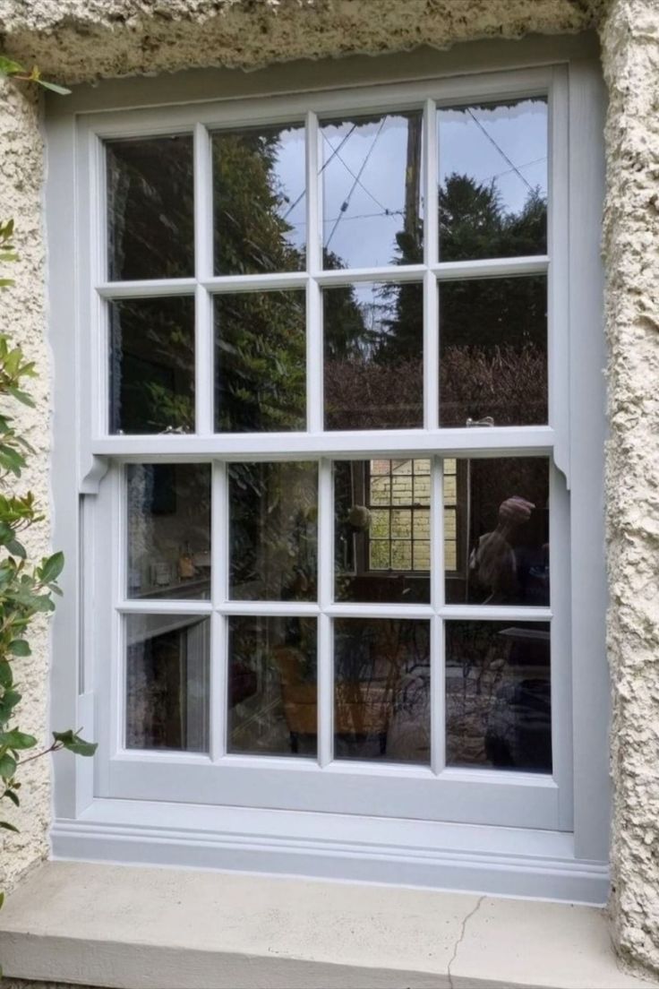 a white window sitting on the side of a building