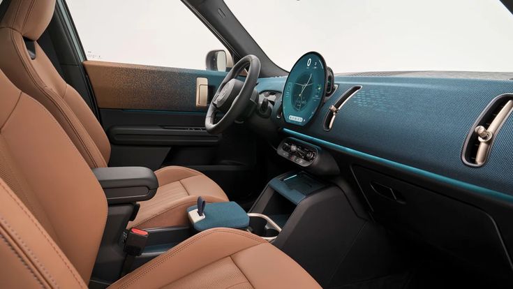 the interior of a car with tan leather seats and blue dash board, steering wheel and center console