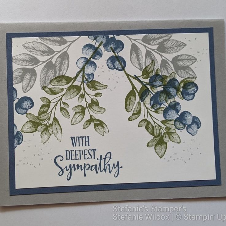 a close up of a card with blue berries on it and the words, with deepest sympathy