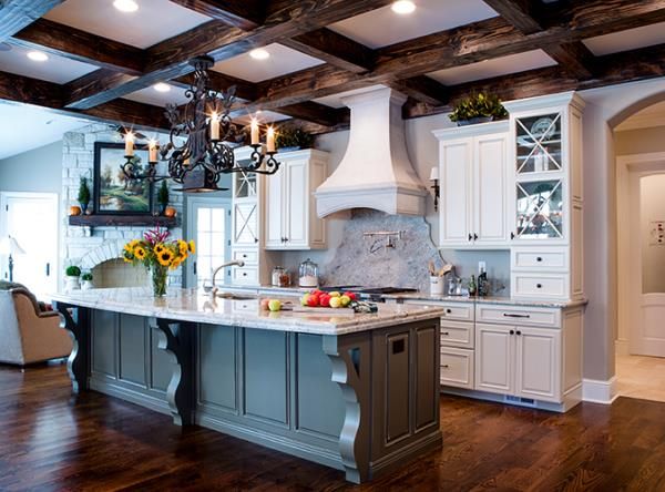 a large kitchen with an island in the middle and lots of cabinets on both sides