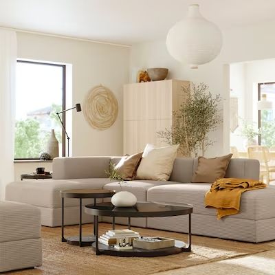 a living room filled with lots of furniture and decor on top of a hard wood floor