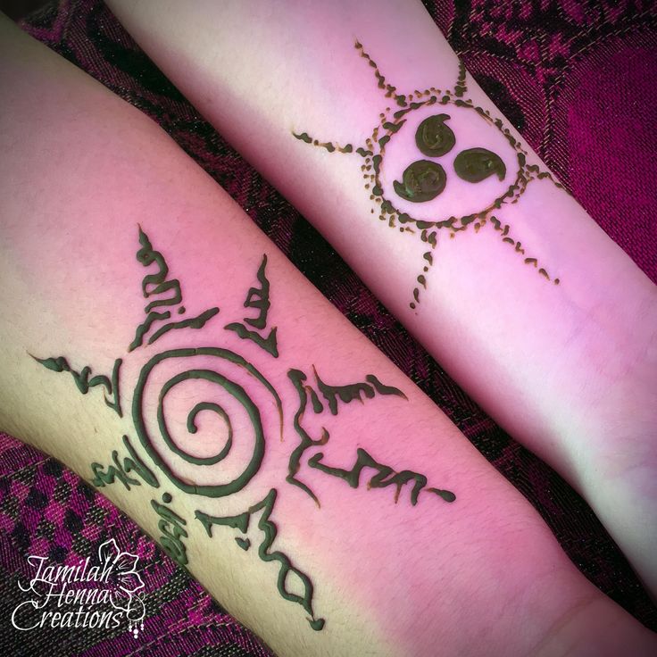 two people with tattoos on their legs and one has a sun in the middle, while the other is an animal