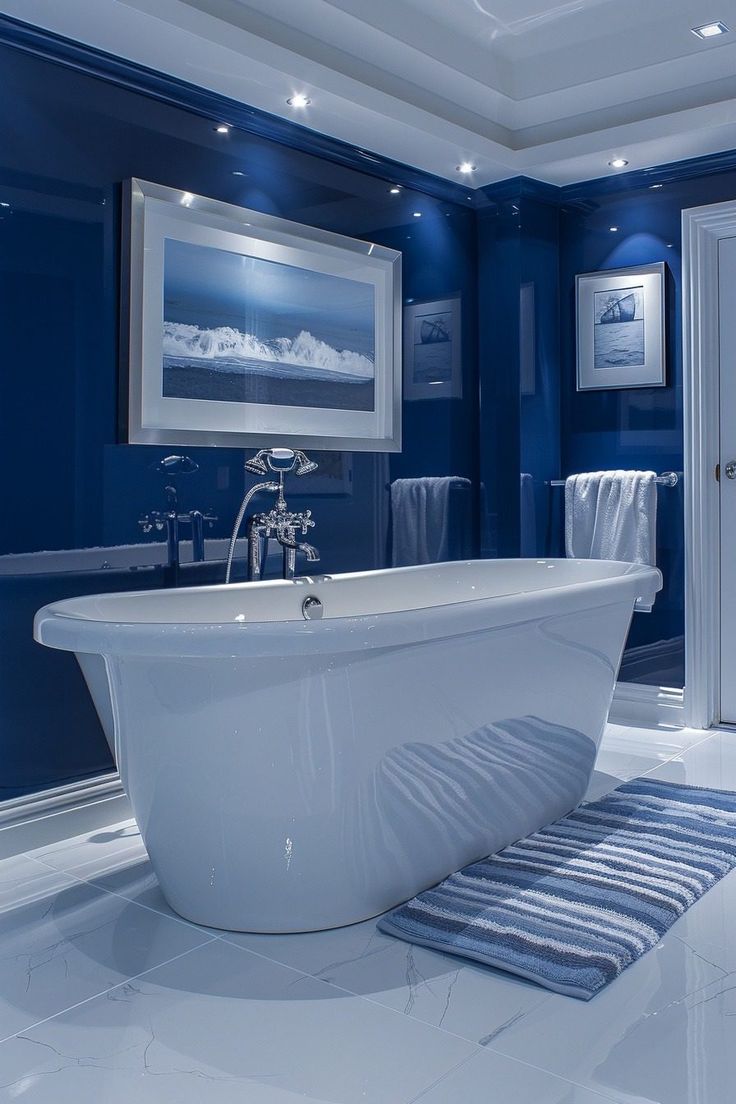 a white bath tub sitting in a bathroom next to a blue wall and rug on the floor