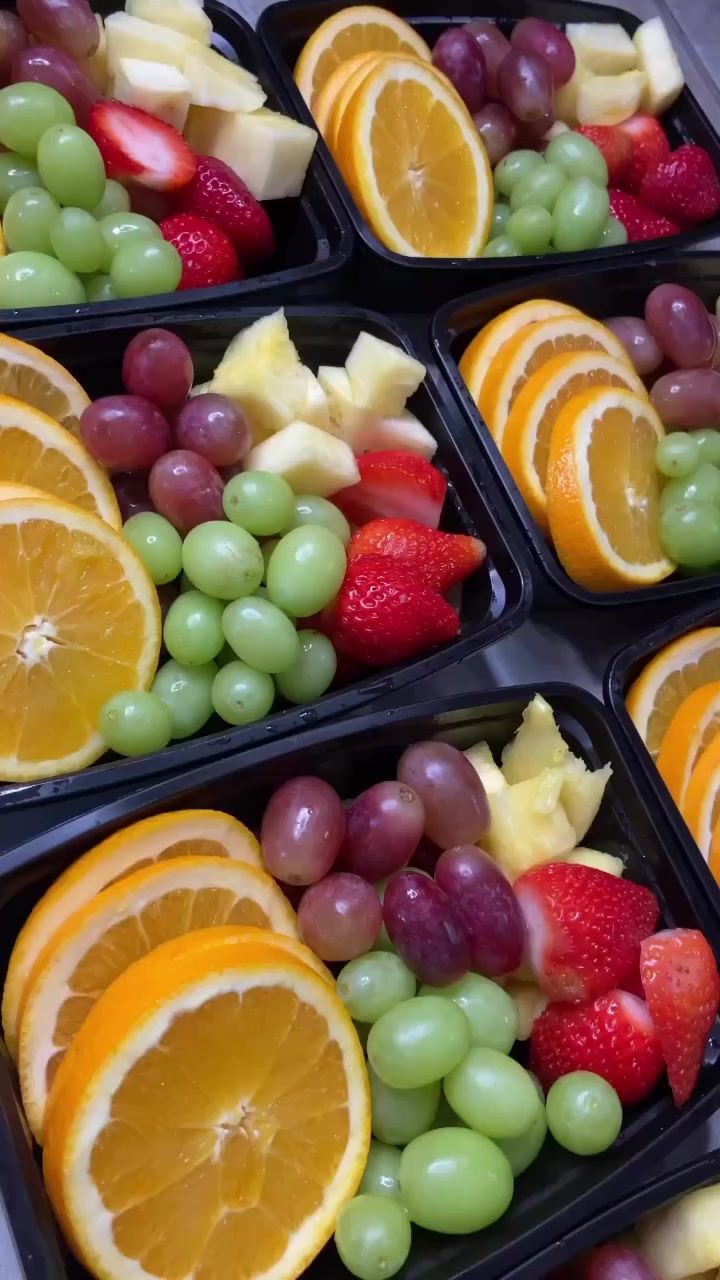 several trays filled with different types of fruit