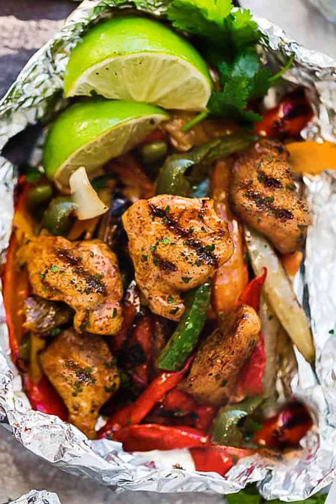 chicken fajita in foil with vegetables and lime