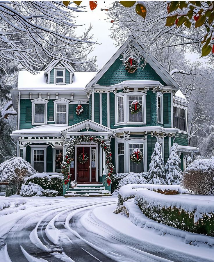 a large green house with wreaths on the front door and windows in snow covered yard