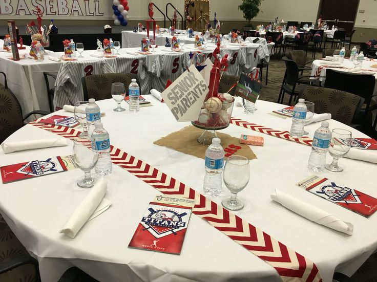 a baseball themed table setting with water bottles and napkins on the table for an event