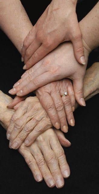 several hands stacked on top of each other