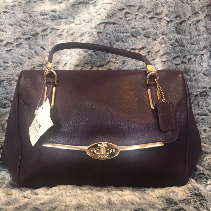 Guaranteed Authentic Coach Madison Small Leather Madeline East/West Satchel Color Is Black Violet With Gold Hardware Size: 13.75” L 7.5” H 4.75” W Handles: 7.5” Drop Shoulder/Crossbody Strap: 21.75” **Last Photo Is Not The Color Of Bag For Sale, It Is For Reference Only** Color Of Bag For Sale Is Black Violet Outside Flap With Turn Lock , 2 Inside Pockets Leather With Satin Lining Purchased At Macy’s Purple Crossbody Satchel With Gold-tone Hardware, Elegant Purple Satchel Shoulder Bag, Classic Purple Evening Bag, Coach Purple Shoulder Bag With Top Carry Handle, Classic Purple Bag With Detachable Handle, Purple Crossbody Satchel For Evening, Purple Top Handle Shoulder Bag For Office, Elegant Purple Top Handle Shoulder Bag, Elegant Purple Top Handle Bag